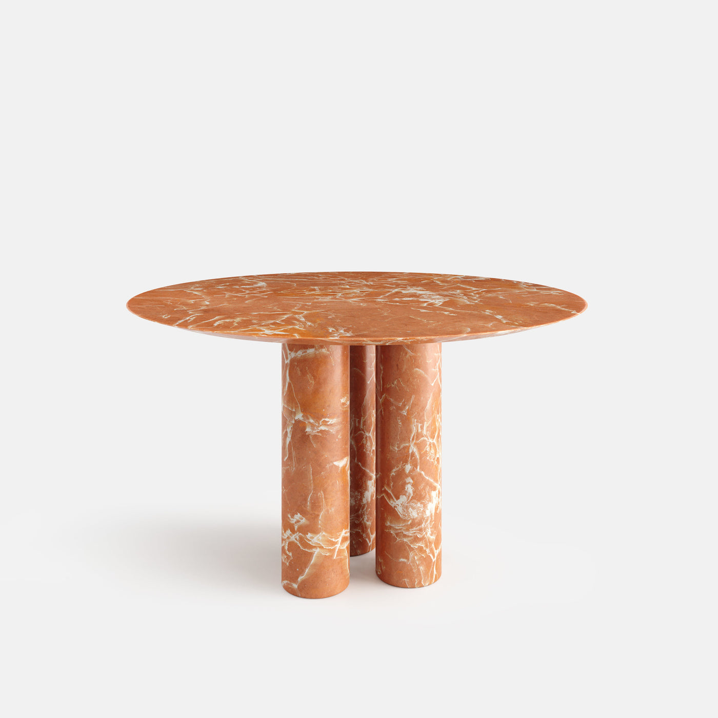 Table à manger ronde Corolle, vue en trois quarts, configuration photographiée en marbre Rosso Alicante.