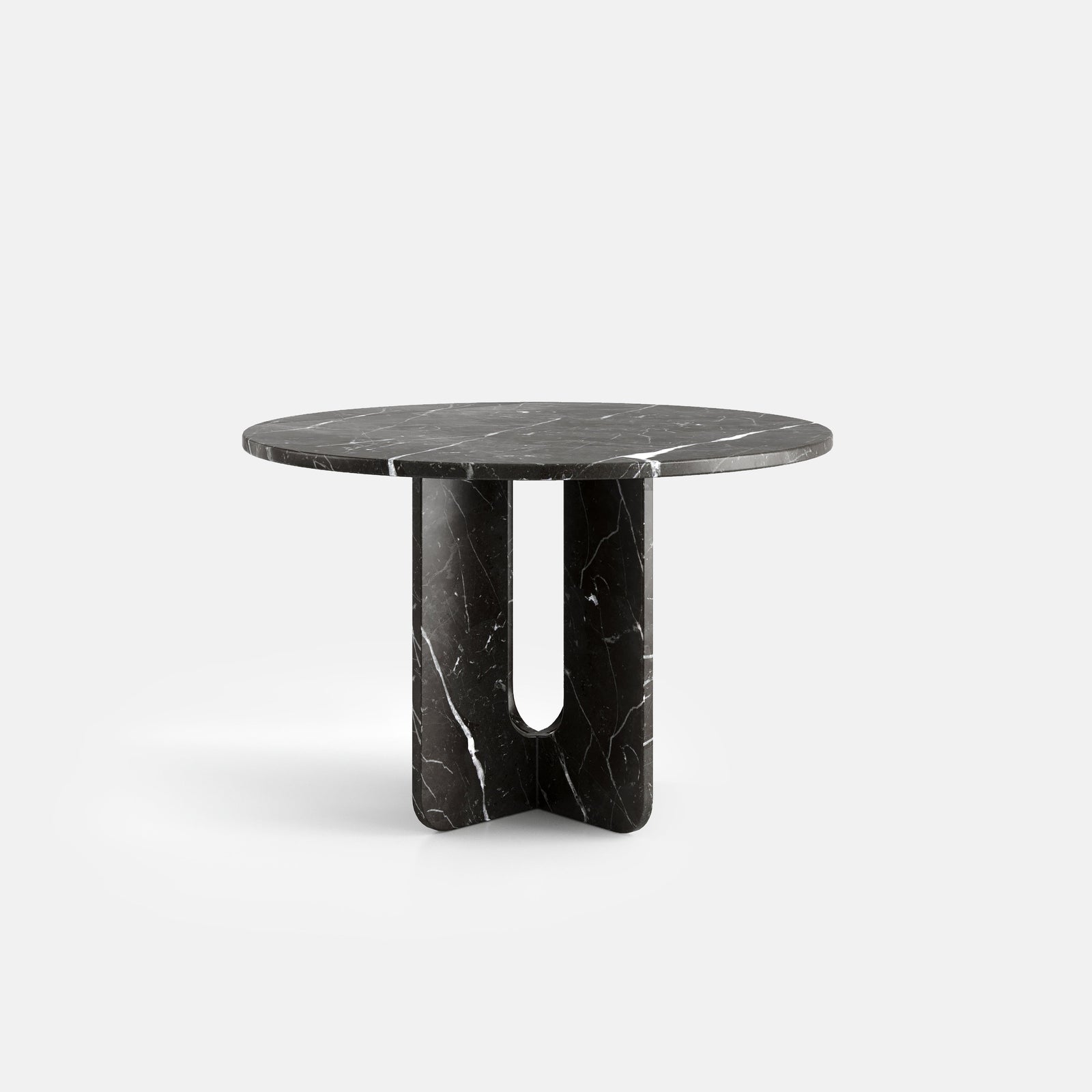 Table à manger ronde Croisée, vue de face, configuration photographiée en marbre Nero Marquina.